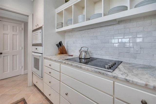 1212 River Club Dr, Sea Island, GA 31561 - kitchen with decorative backsplash, white appliances, and white cabinets