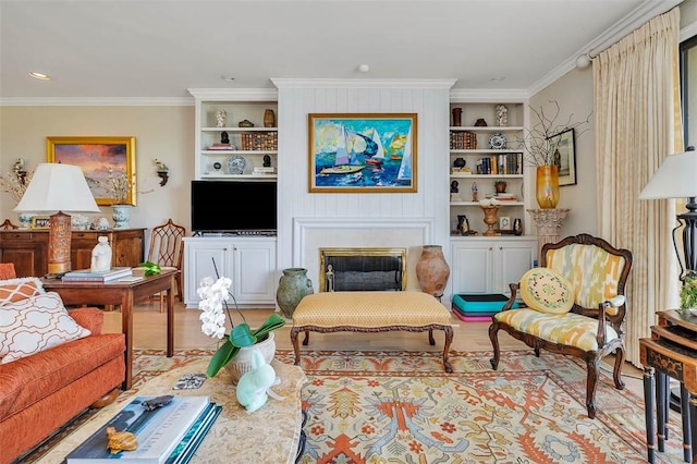1212 River Club Dr, Sea Island, GA 31561 - living room featuring built in shelves, wood finished floors, crown molding, and a glass covered fireplace