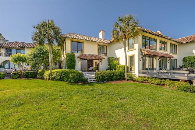 1212 River Club Dr, Sea Island, GA 31561 - back of property featuring a chimney, a tile roof, and stucco siding