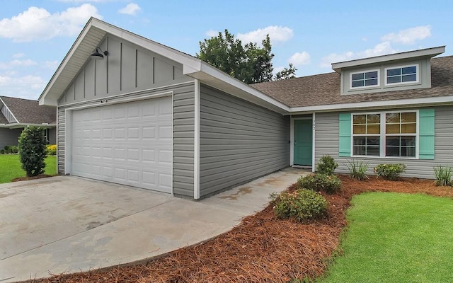 352 Pecan Pointe Dr, Brunswick, GA 31525 - ranch-style home featuring a shingled roof, board and batten siding, an attached garage, and a front yard