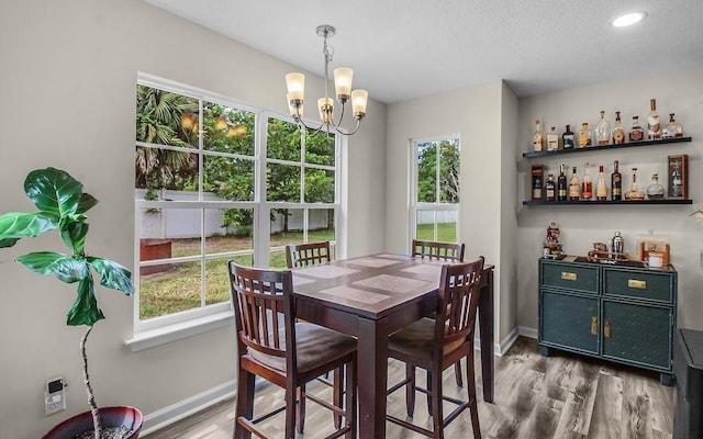 352 Pecan Pointe Dr, Brunswick, GA 31525 - dining room featuring healthy amount of natural light, a chandelier, light wood-style floors, a dry bar, and recessed lighting