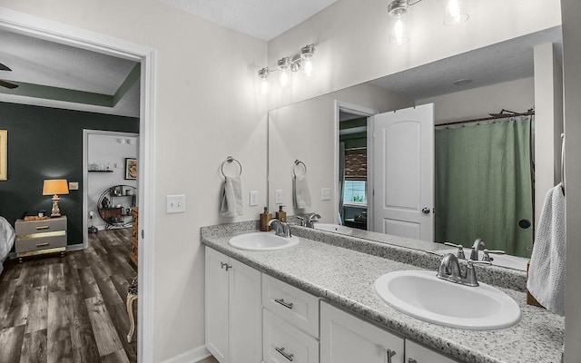 352 Pecan Pointe Dr, Brunswick, GA 31525 - ensuite bathroom featuring double vanity and wood finished floors