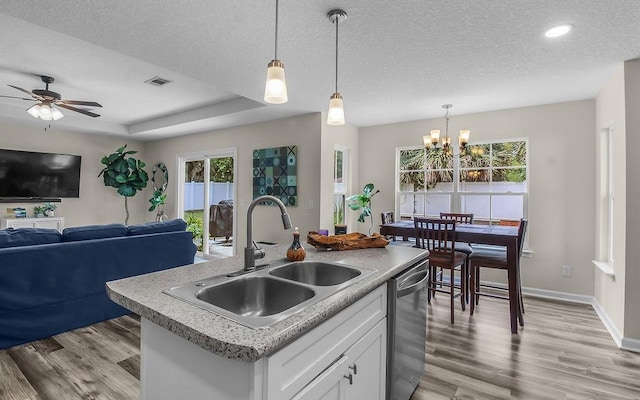 352 Pecan Pointe Dr, Brunswick, GA 31525 - kitchen featuring dishwasher, open floor plan, light wood finished floors, an island with sink, and a chandelier
