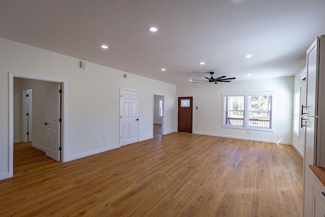 unfurnished living room featuring light wood-type flooring, recessed lighting, baseboards, and ceiling fan
