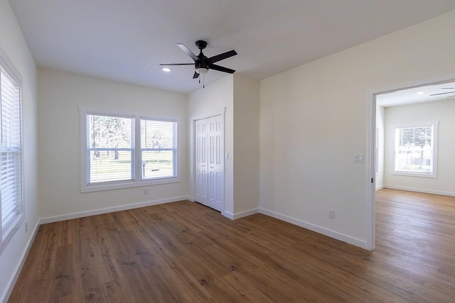 unfurnished bedroom featuring recessed lighting, baseboards, a ceiling fan, a closet, and wood finished floors