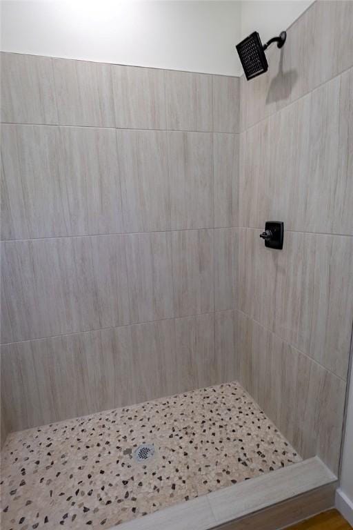 full bathroom with tiled shower