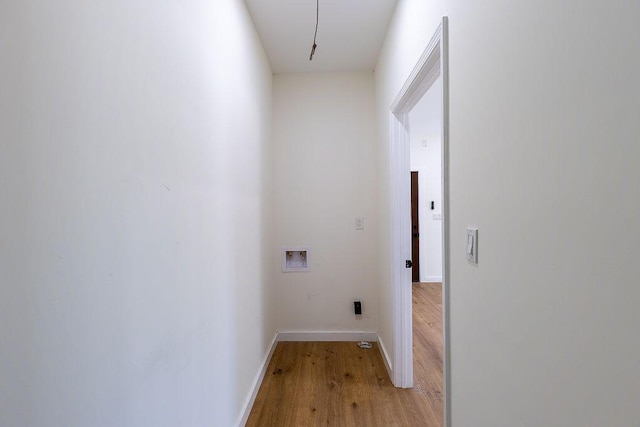 laundry area featuring light wood-style flooring, hookup for a washing machine, baseboards, and laundry area