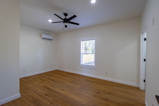 unfurnished room with baseboards, ceiling fan, wood finished floors, recessed lighting, and an AC wall unit