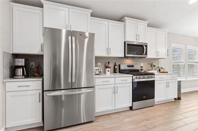 316 Chinquapin Dr, Saint Marys, GA 31558 - kitchen featuring appliances with stainless steel finishes, white cabinetry, backsplash, and light countertops