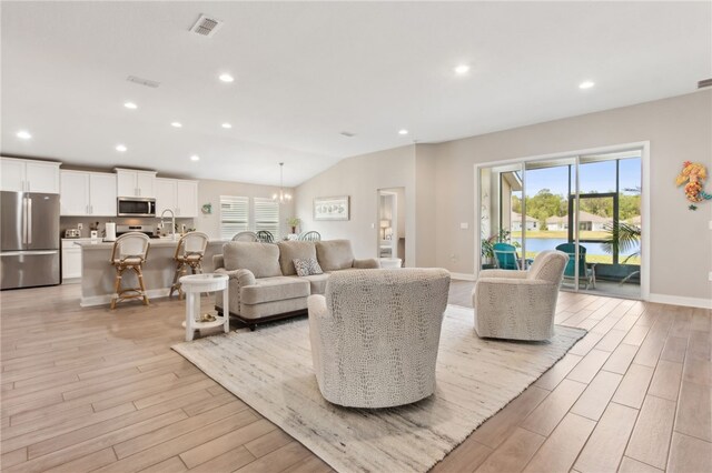 316 Chinquapin Dr, Saint Marys, GA 31558 - living area featuring light wood finished floors, healthy amount of natural light, recessed lighting, a chandelier, and vaulted ceiling