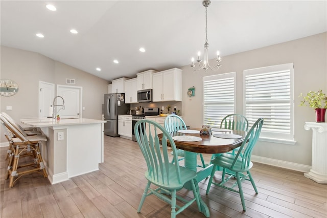 316 Chinquapin Dr, Saint Marys, GA 31558 - dining space with a chandelier, light wood-type flooring, vaulted ceiling, recessed lighting, and baseboards