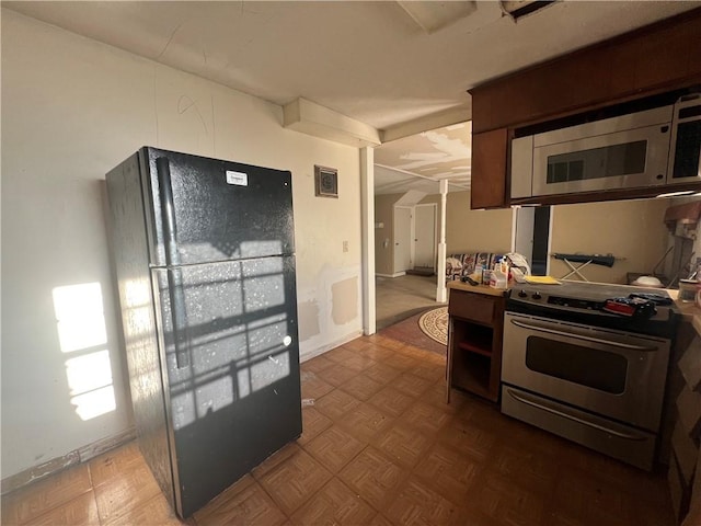 kitchen with parquet floors and appliances with stainless steel finishes