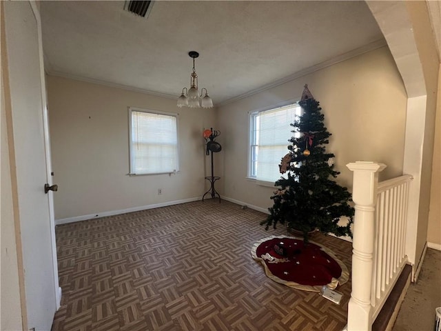 interior space featuring dark parquet flooring, an inviting chandelier, and ornamental molding