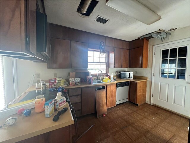 kitchen with dark parquet flooring, sink, and appliances with stainless steel finishes