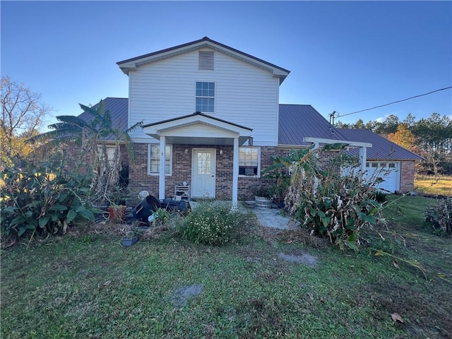 view of front of property with a front yard and a garage