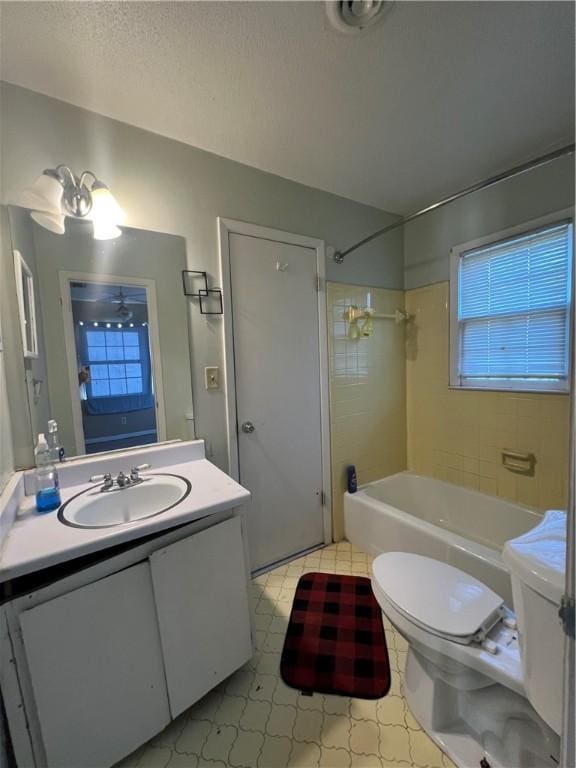 full bathroom featuring vanity, toilet, and tiled shower / bath