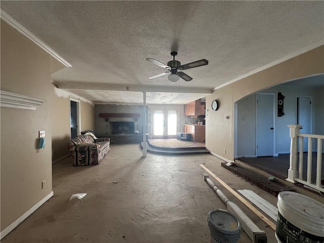 misc room featuring ceiling fan, crown molding, a textured ceiling, and french doors