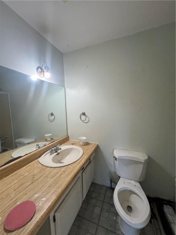 bathroom with tile patterned floors, vanity, and toilet