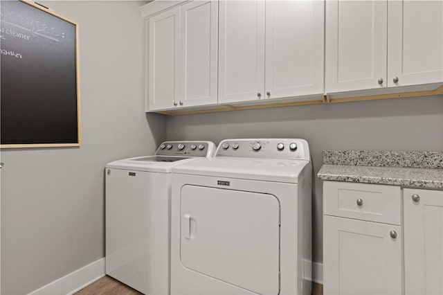 636 Old Plantation Rd, Jekyll Island, GA 31527 - clothes washing area with washer and clothes dryer, cabinet space, and baseboards