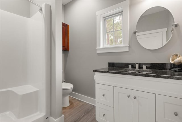636 Old Plantation Rd, Jekyll Island, GA 31527 - bathroom with a shower, vanity, toilet, wood finished floors, and baseboards