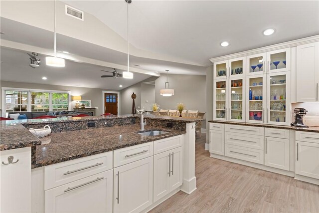 636 Old Plantation Rd, Jekyll Island, GA 31527 - kitchen with a sink, light wood-type flooring, recessed lighting, white cabinetry, and hanging light fixtures