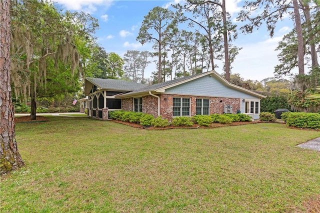 636 Old Plantation Rd, Jekyll Island, GA 31527 - view of front facade with brick siding and a front yard