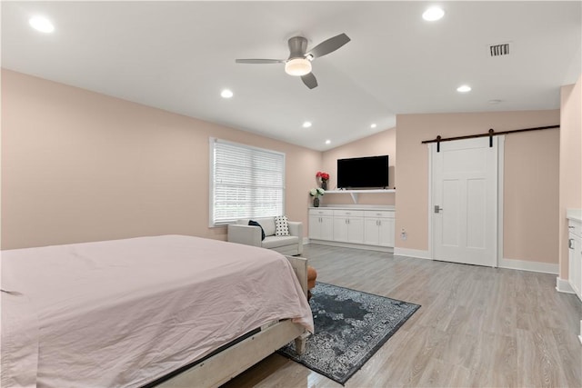 636 Old Plantation Rd, Jekyll Island, GA 31527 - bedroom with a barn door, light wood finished floors, vaulted ceiling, recessed lighting, and baseboards
