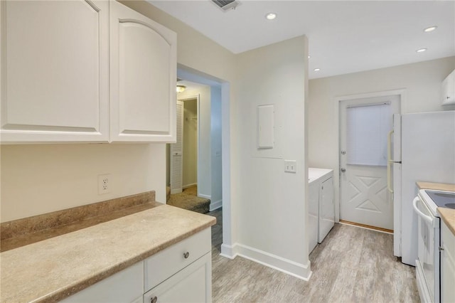 kitchen with white electric range oven, washing machine and dryer, light hardwood / wood-style flooring, and white cabinetry