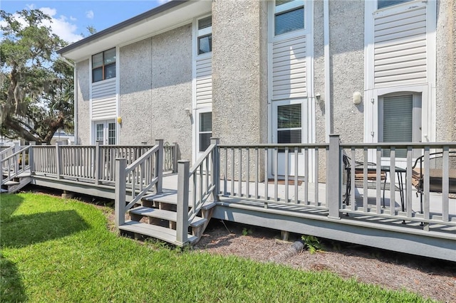 rear view of house featuring a wooden deck