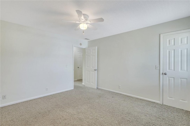 empty room with ceiling fan and light colored carpet