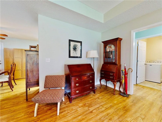2300 Albany Ave, Waycross, GA 31503 - living area with washer / dryer, light wood finished floors, and a ceiling fan
