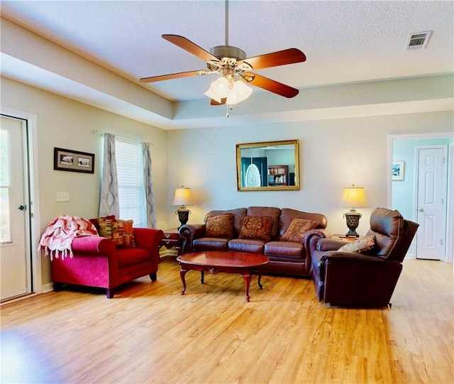 2300 Albany Ave, Waycross, GA 31503 - living room with light wood-type flooring, a ceiling fan, and a raised ceiling