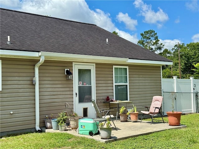 2300 Albany Ave, Waycross, GA 31503 - back of property with a shingled roof and a patio area