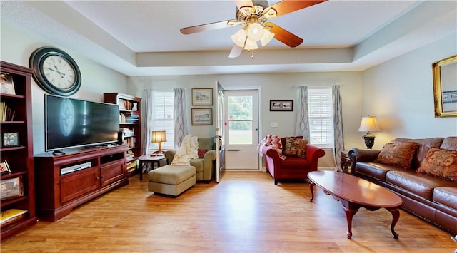 2300 Albany Ave, Waycross, GA 31503 - living area featuring a raised ceiling, light wood finished floors, and a ceiling fan