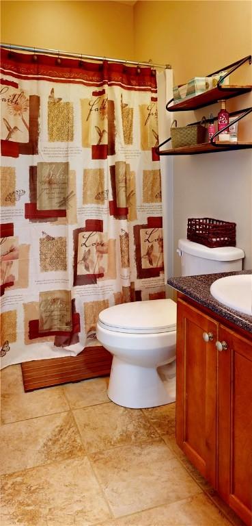 2300 Albany Ave, Waycross, GA 31503 - bathroom with vanity, toilet, and a shower with shower curtain