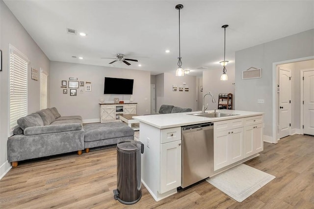 63 Greyfield Dr, Brunswick, GA 31525 - kitchen featuring stainless steel dishwasher, a sink, open floor plan, a kitchen island with sink, and white cabinets