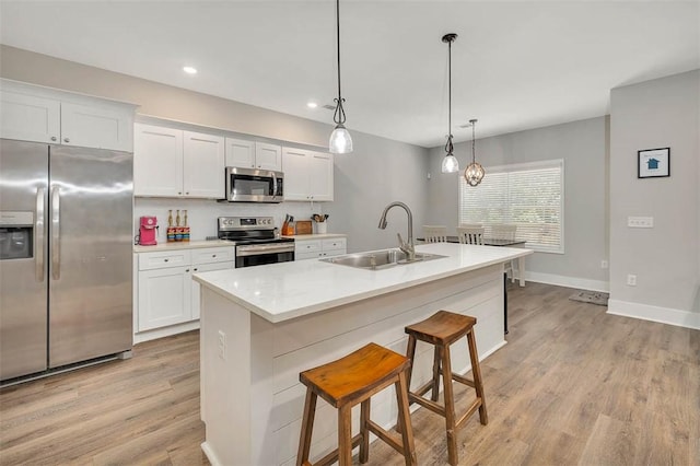63 Greyfield Dr, Brunswick, GA 31525 - kitchen featuring stainless steel appliances, a sink, light wood-style flooring, white cabinets, and recessed lighting