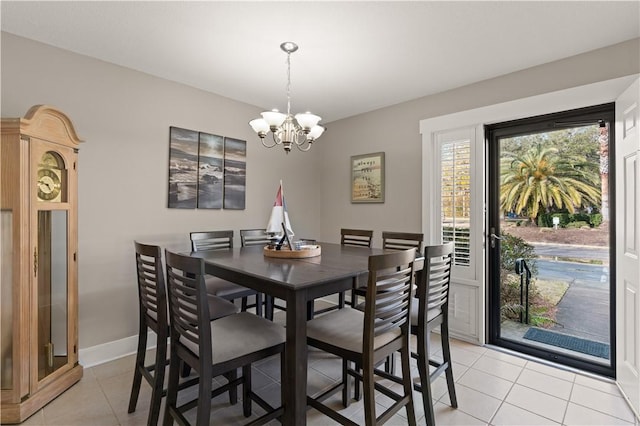 dining space featuring an inviting chandelier and light tile patterned floors