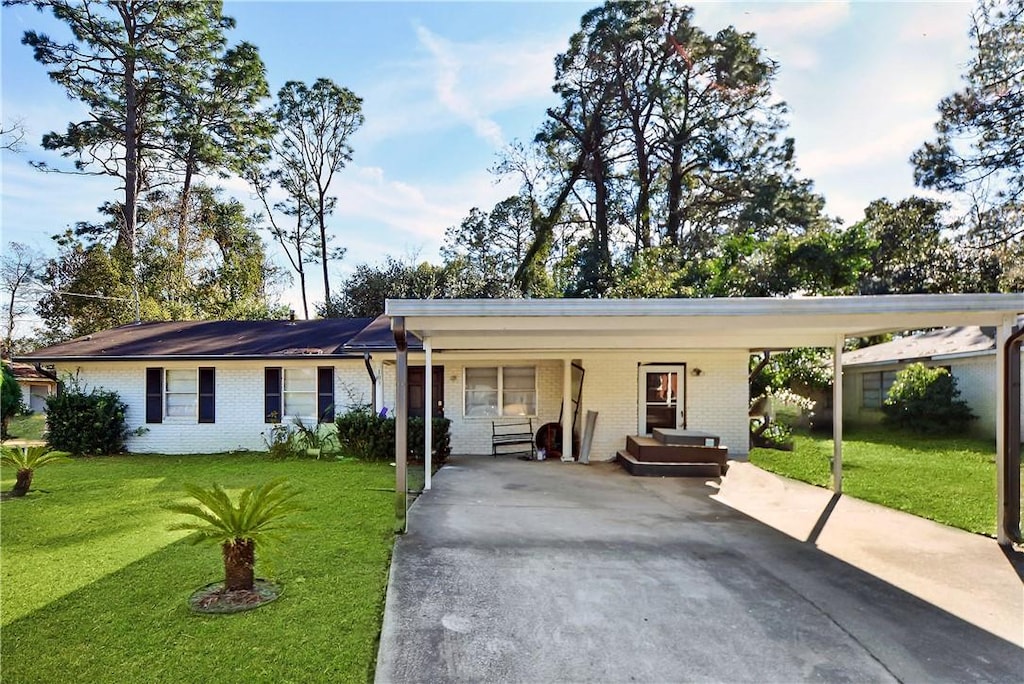 ranch-style house with a carport and a front yard