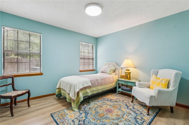 70 Buntin St, Woodbine, GA 31569 - bedroom featuring wood finished floors and a textured ceiling