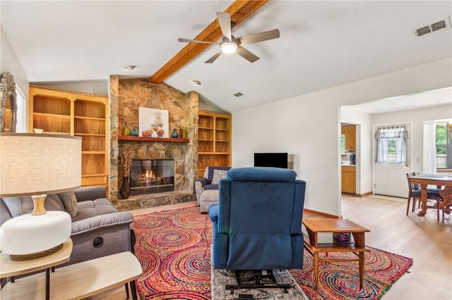 70 Buntin St, Woodbine, GA 31569 - living area featuring wood finished floors, a ceiling fan, and a stone fireplace