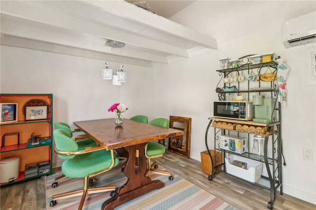 70 Buntin St, Woodbine, GA 31569 - dining room with a wall unit AC, wood finished floors, and beamed ceiling