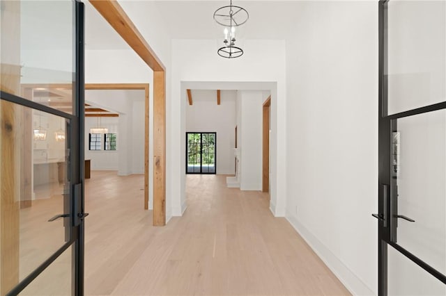 104 Point Ln, Saint Simons Island, GA 31522 - hall featuring light wood-type flooring and a chandelier