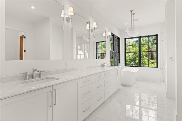 104 Point Ln, Saint Simons Island, GA 31522 - full bath featuring marble finish flooring, double vanity, a soaking tub, recessed lighting, and a chandelier