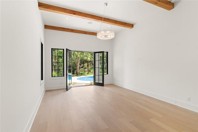 104 Point Ln, Saint Simons Island, GA 31522 - empty room featuring beamed ceiling, light wood-style flooring, a chandelier, and recessed lighting