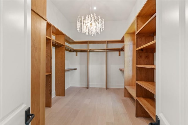 104 Point Ln, Saint Simons Island, GA 31522 - spacious closet with light wood-style flooring and a chandelier