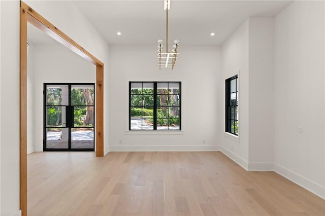 104 Point Ln, Saint Simons Island, GA 31522 - unfurnished room with light wood-style floors, plenty of natural light, a chandelier, and recessed lighting
