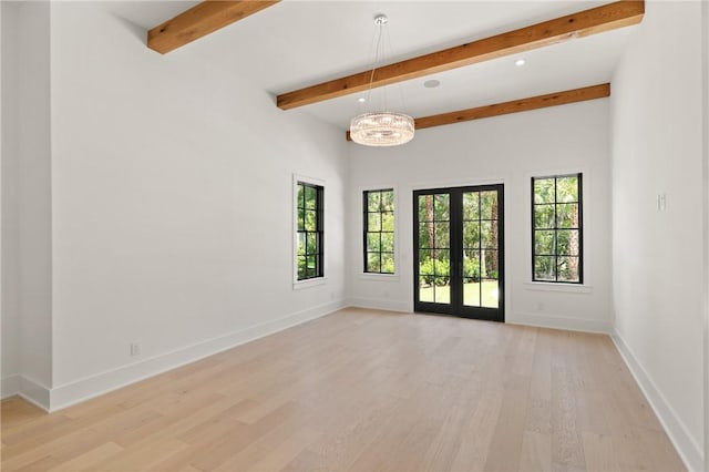 104 Point Ln, Saint Simons Island, GA 31522 - unfurnished room with light wood-style flooring, beamed ceiling, a chandelier, and french doors