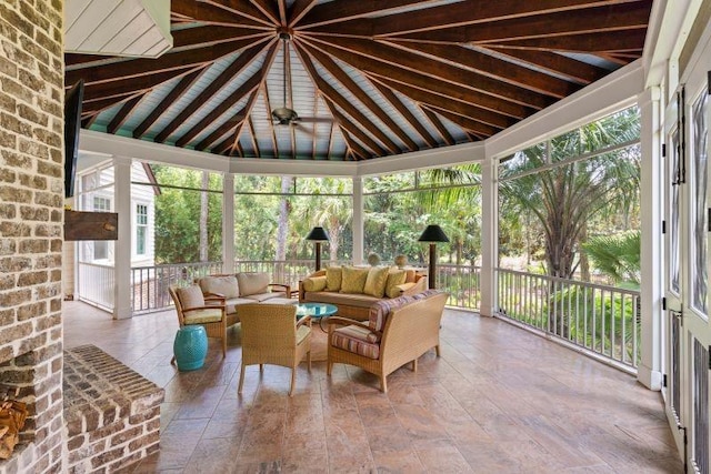 sunroom with vaulted ceiling with beams and ceiling fan