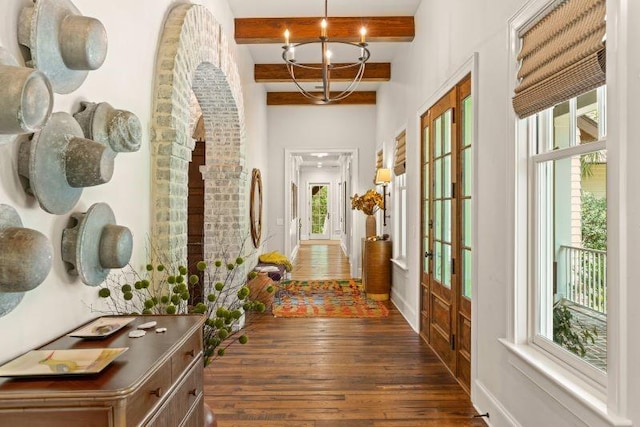 hall featuring a chandelier, beam ceiling, dark hardwood / wood-style floors, and french doors